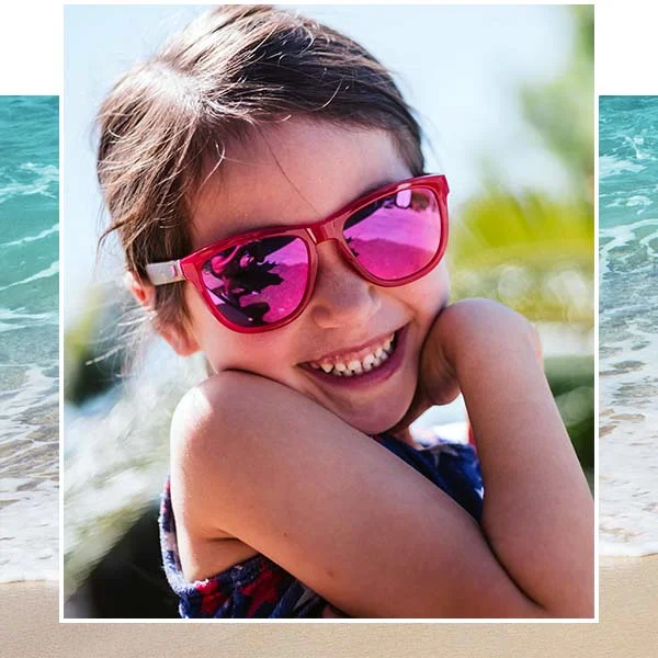 A young girls outside in sunglasses.