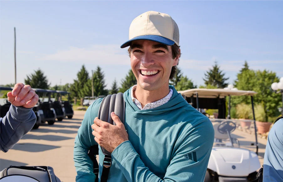 Guy smiling with adida golf gear