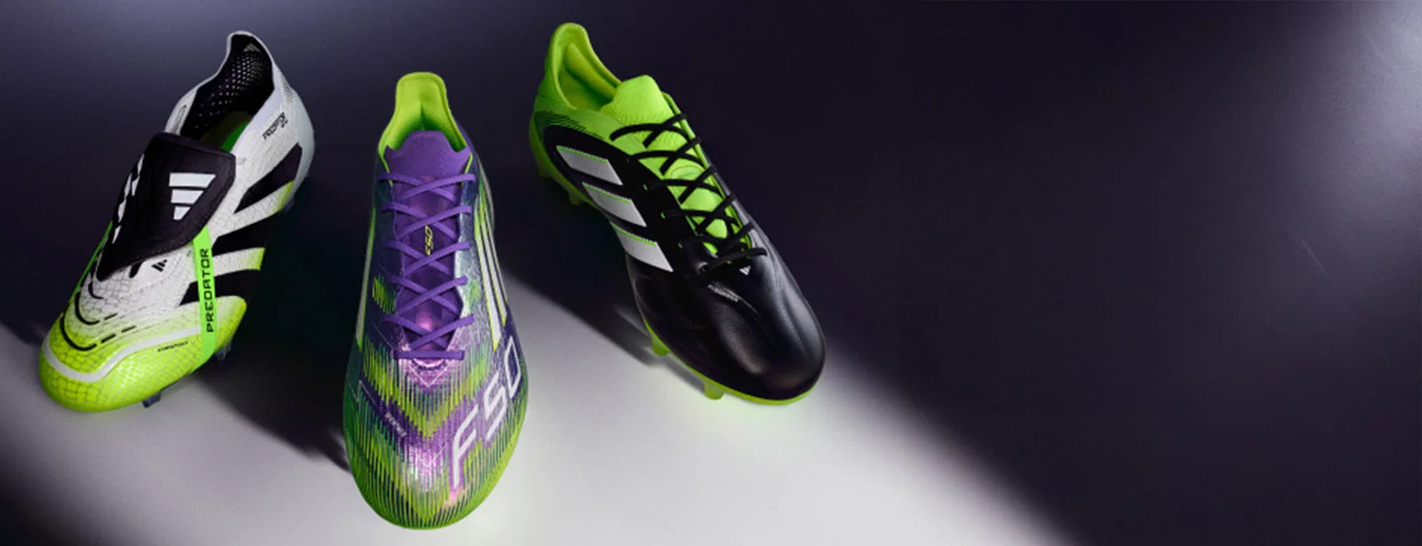 Adidas cleats on studio floor.