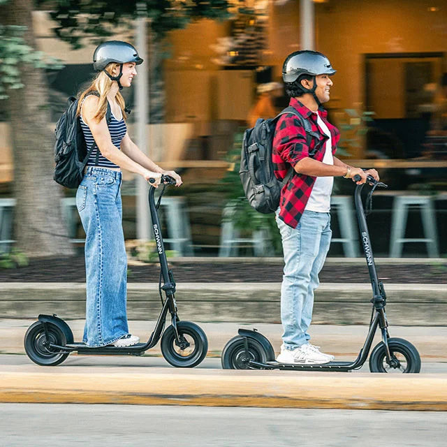 Athletes on scooters outdoors.