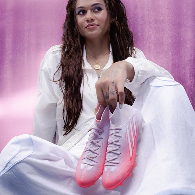 Trinity Rodman holding a soccer cleat.