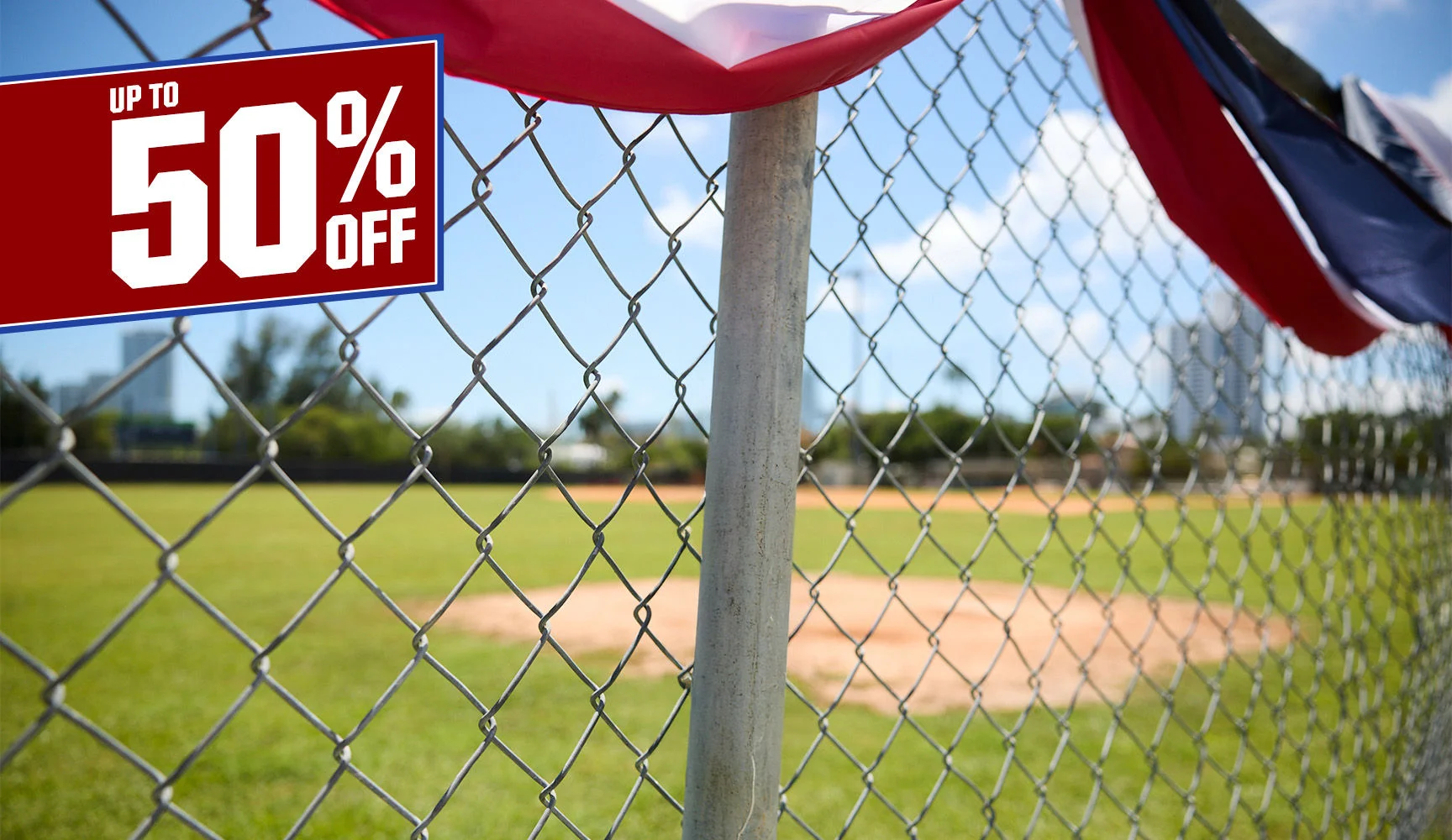 Up to 50% Off. Patriotic banners on a baseball fence.