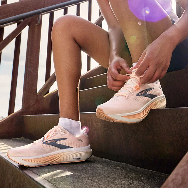 Athletes outdoors tying shoes.