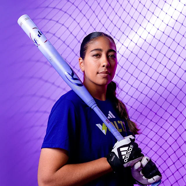 Athlete holding softball bat.