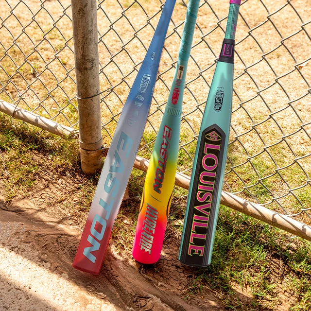 Three Bats leaning on fence