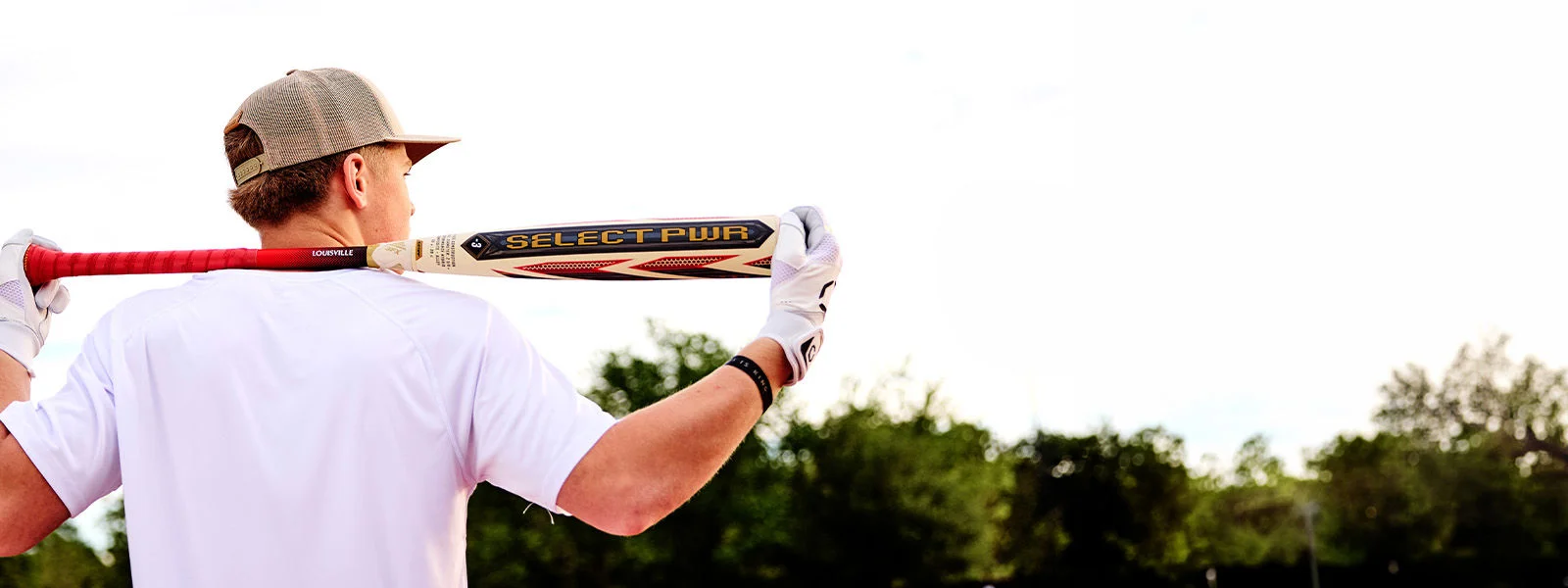 Baseball player holding bat.