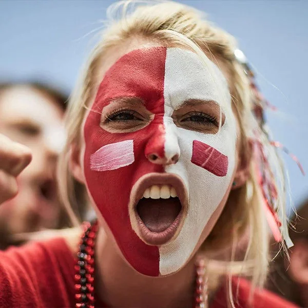 A fan with her face painted.