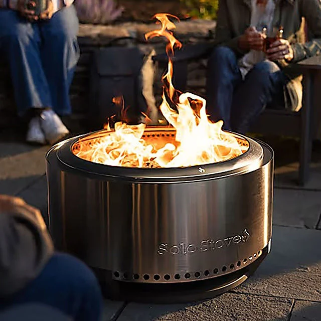 People huddled around a solo stove.