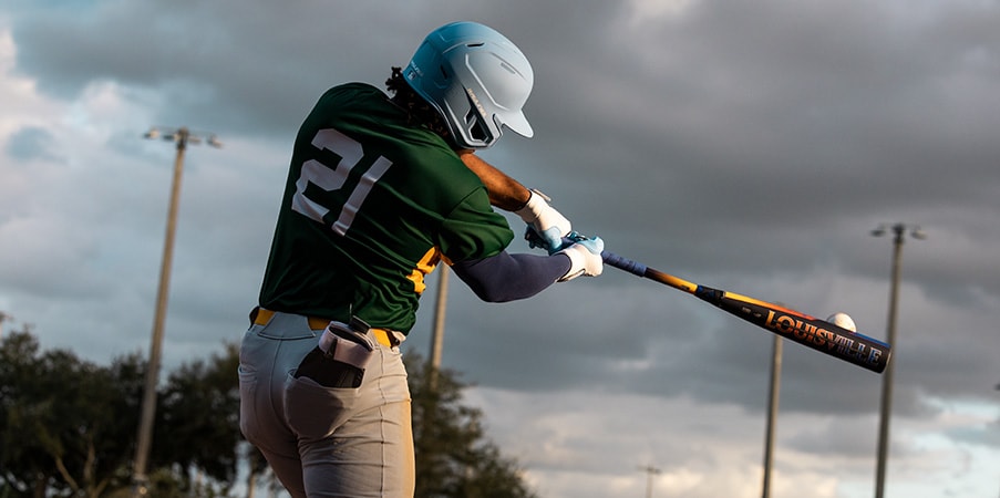 Baseball player hitting ball.