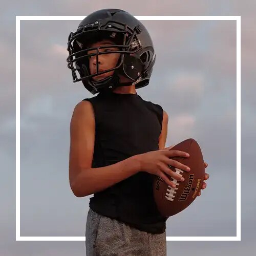 A young boy with a football.