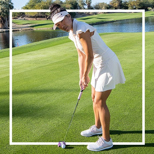 A woman golfing.