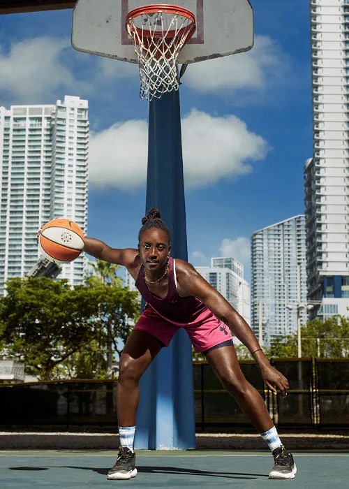 Woman playing basketball.