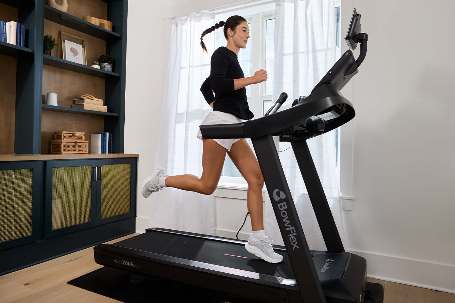 person running on treadmill in home gym