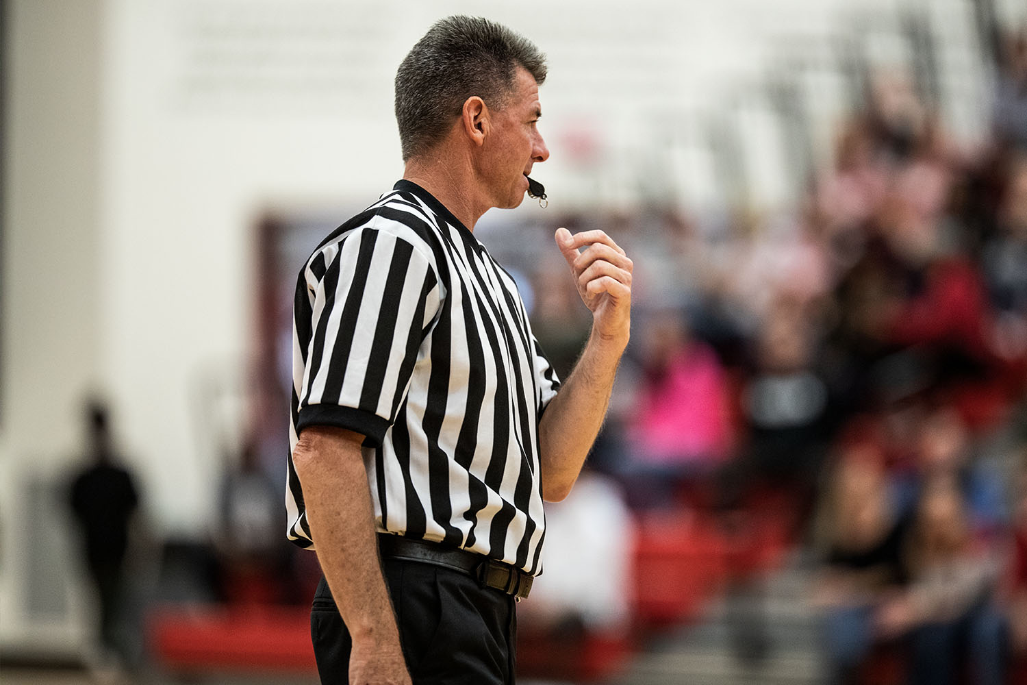 Referee blowing whistle on court