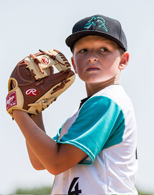 Baseball player holing ball in glove