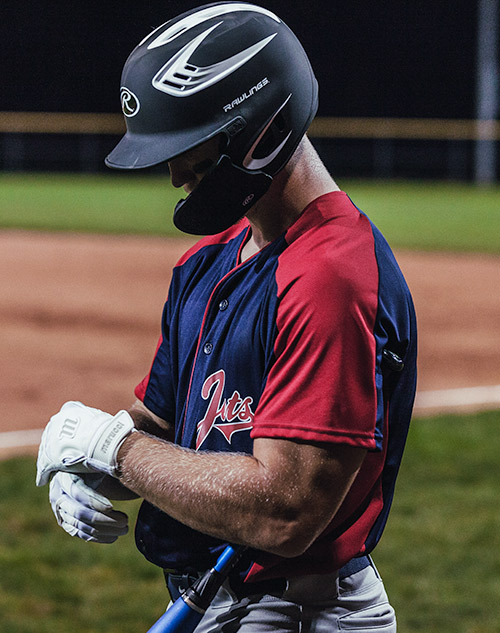Baseball player putting on gloves