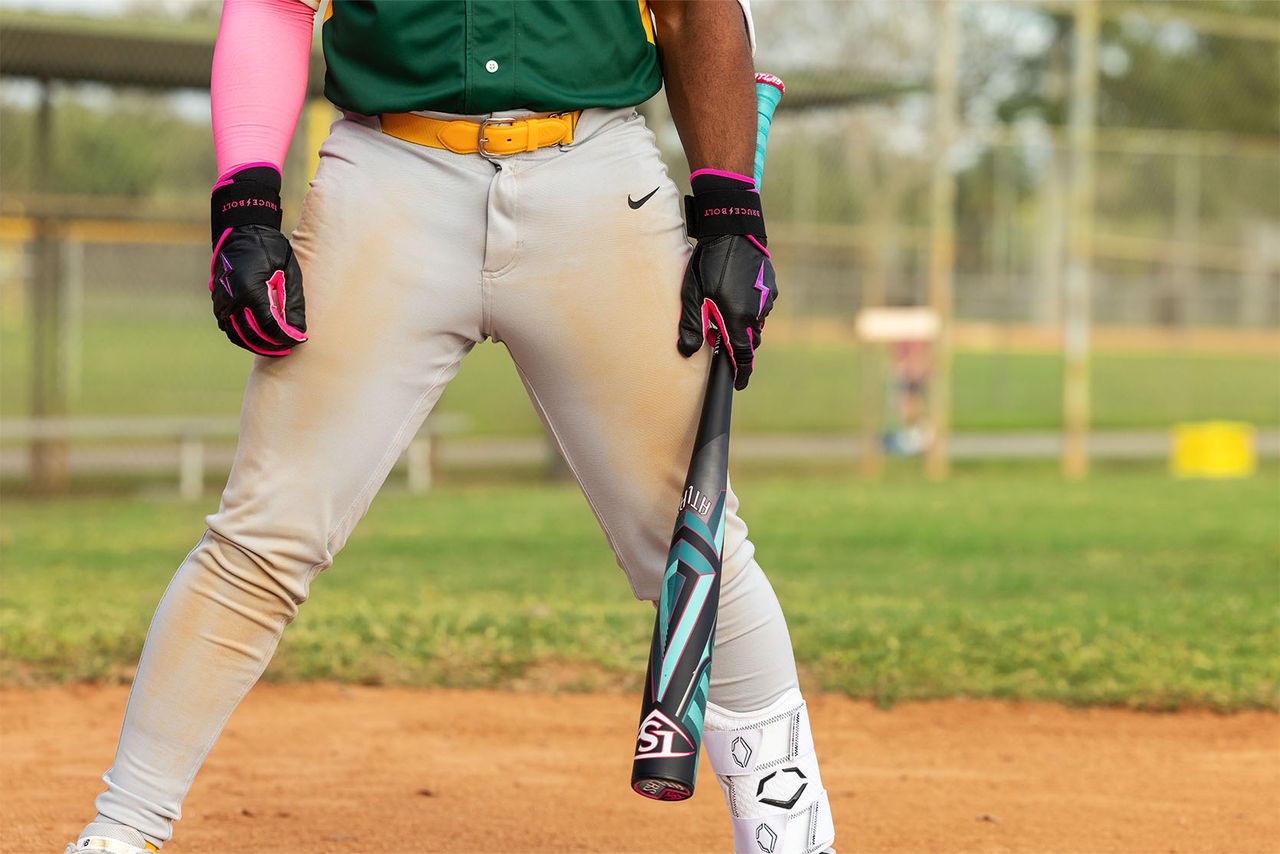 person standing in batters box holding bat