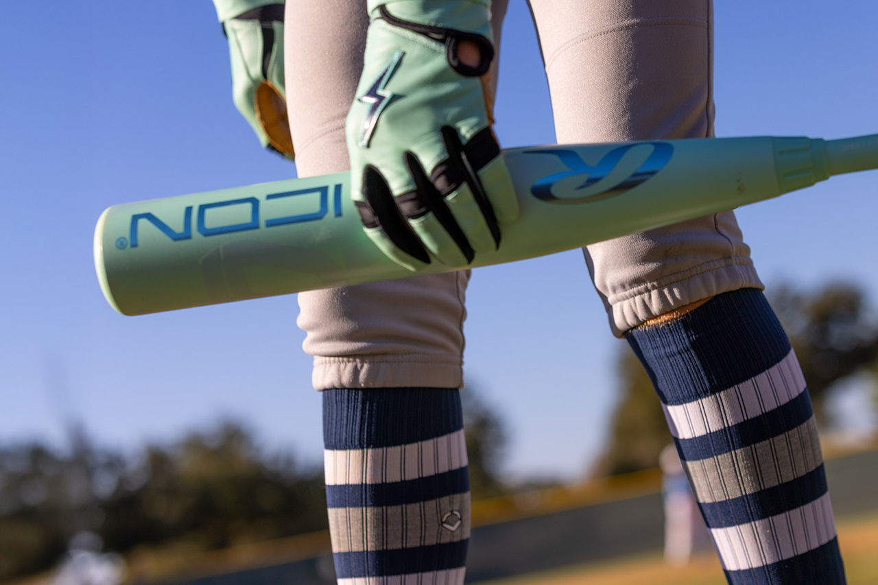 Baseball player holding baseball bat.