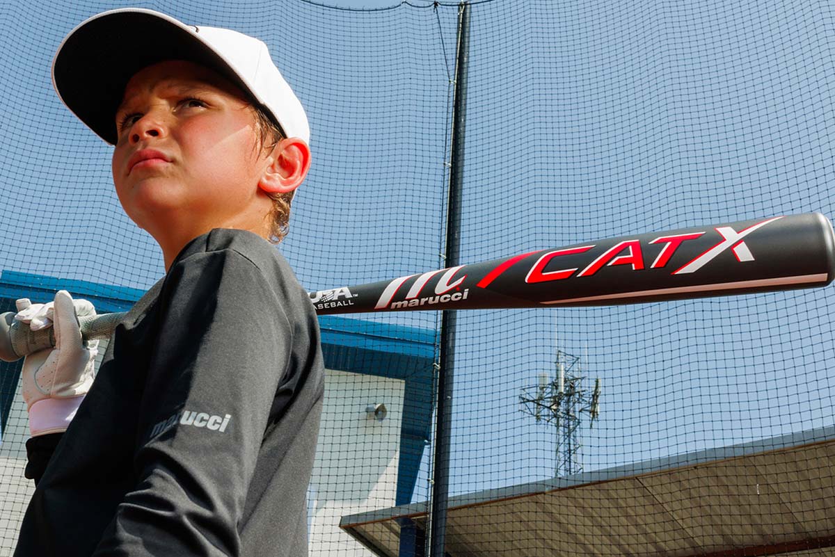 looking at a baseball field through a dugout cage 
