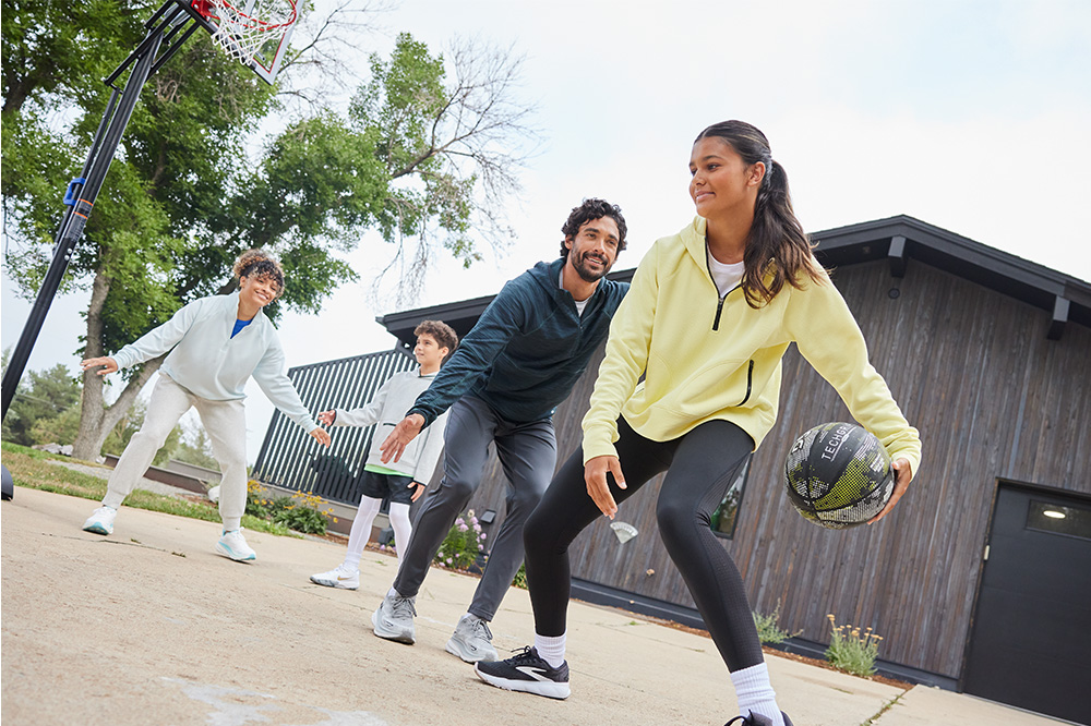 Family playing basketball in their driveway