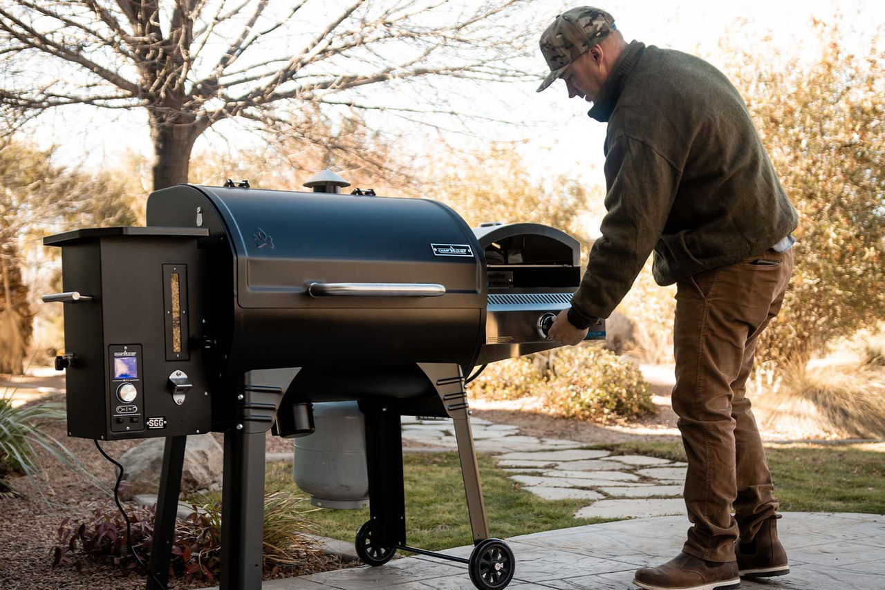 man cooking at grill