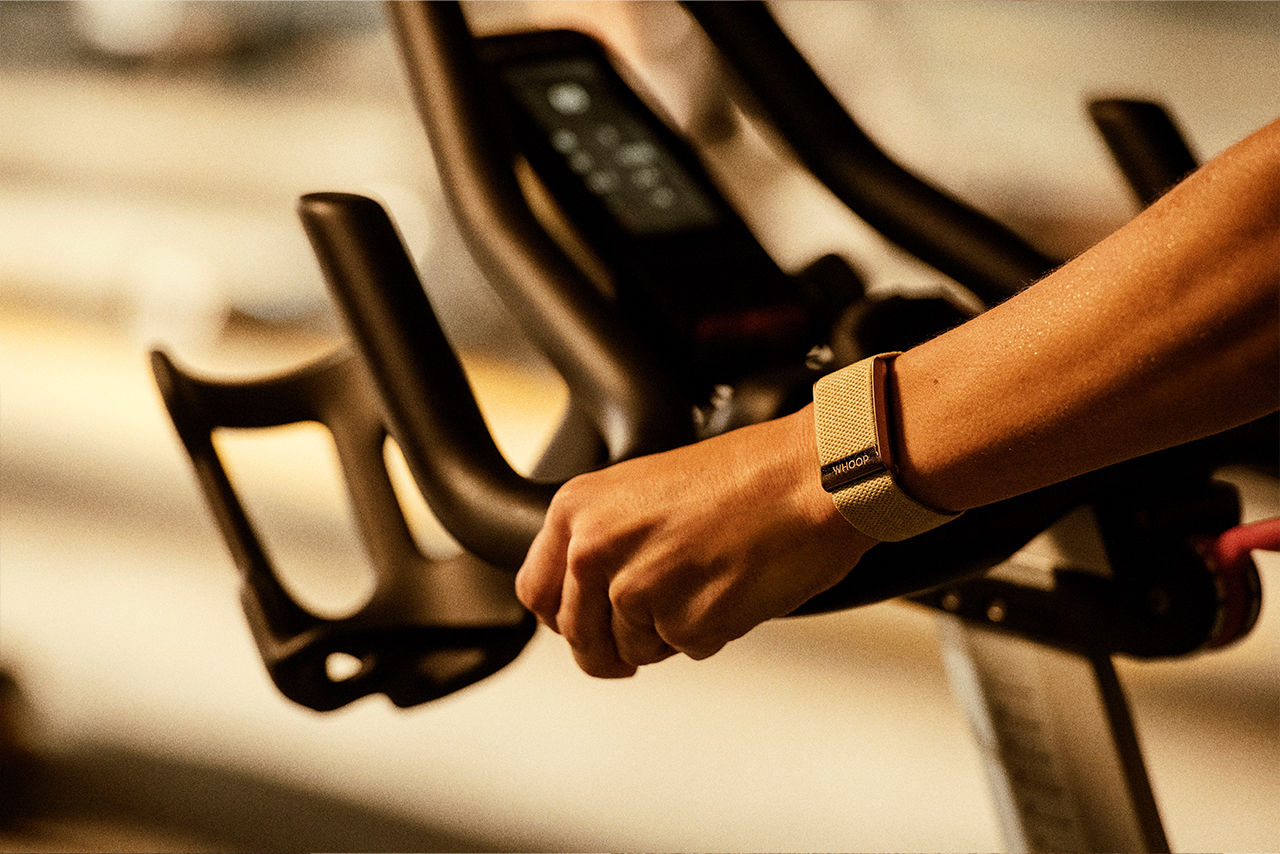 Athlete wearing fitness tracker on a treadmill.