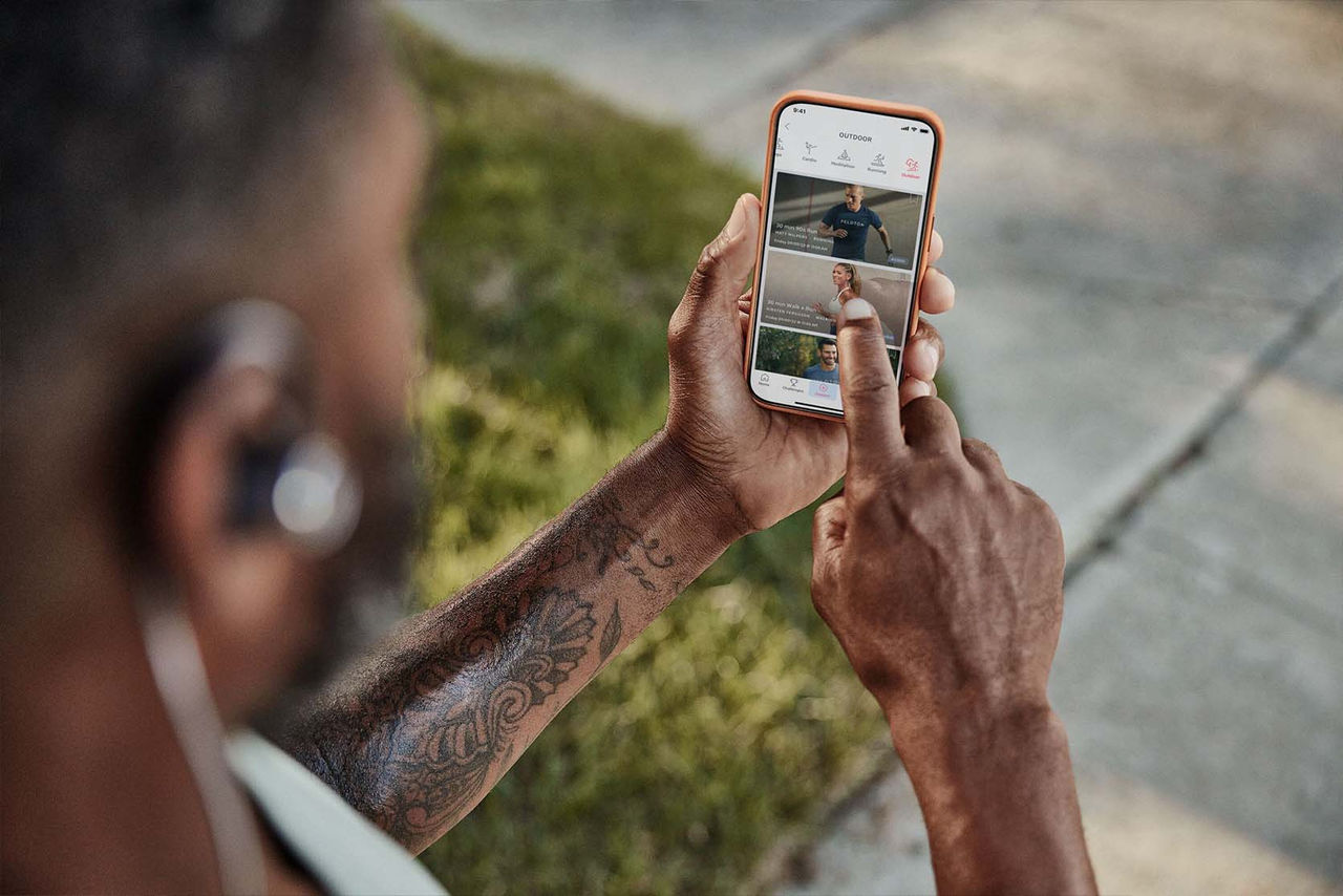 man using peloton app 