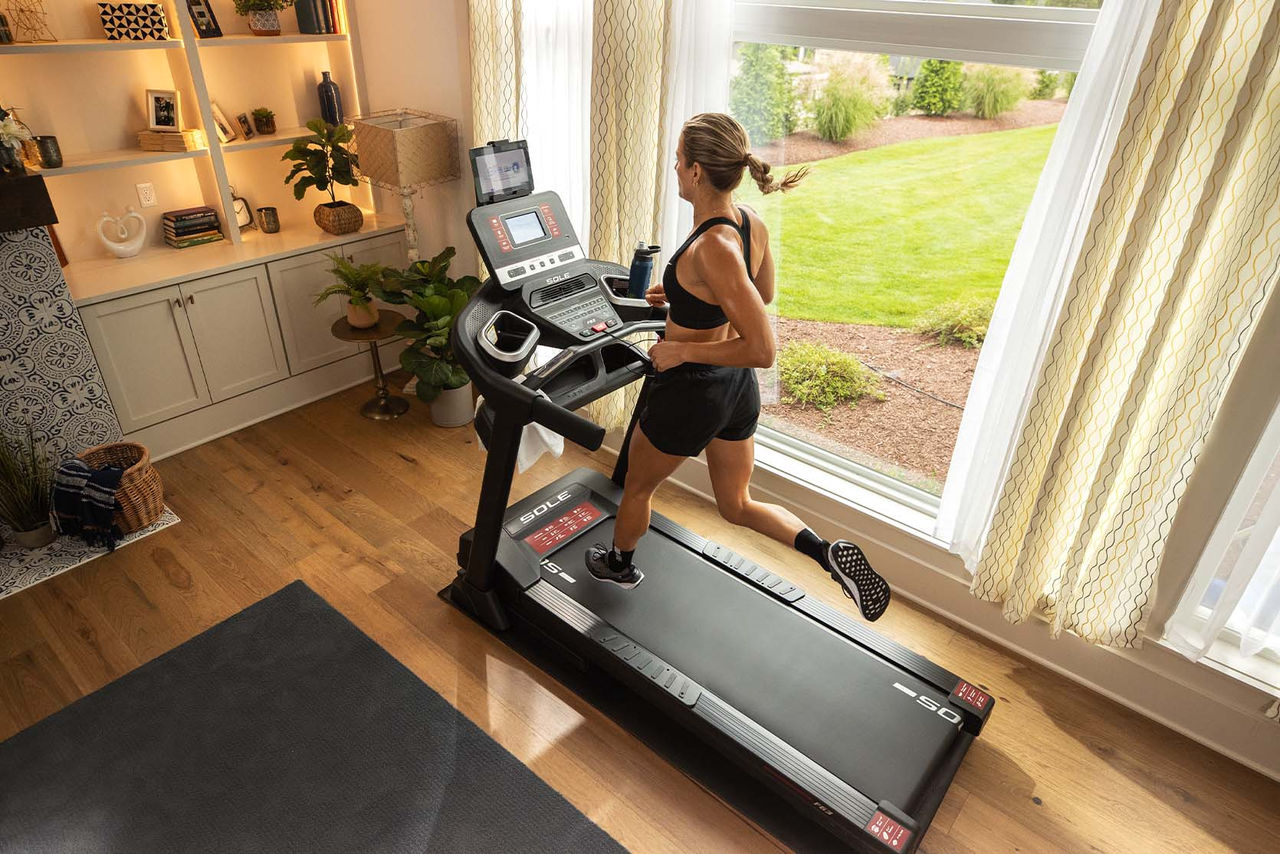 Woman running on treadmill in her home