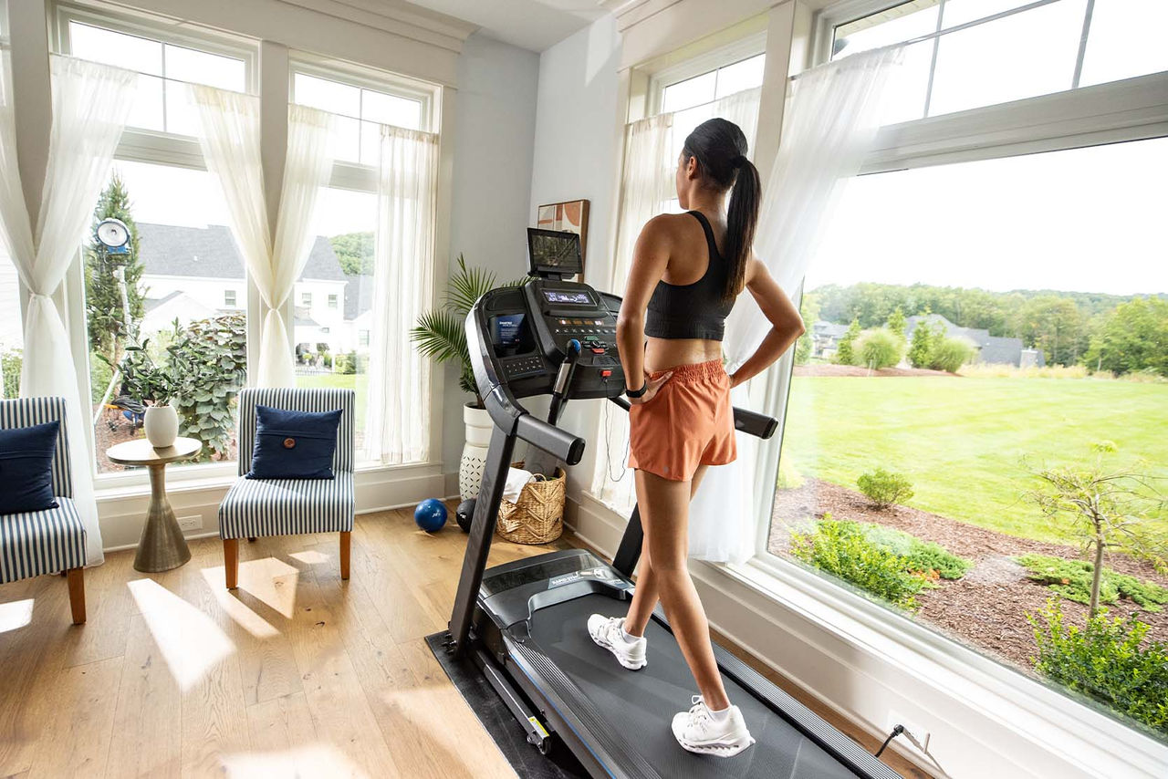 woman running on treadmill in modern living room