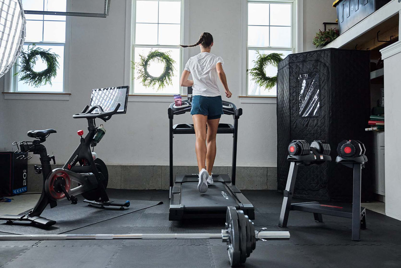girl running on treadmill in home gym
