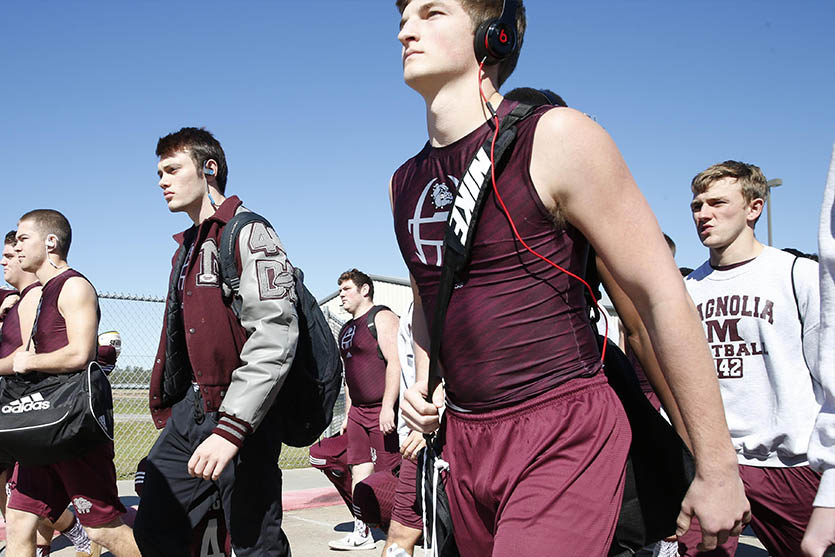 An image of football players walking to practice. 