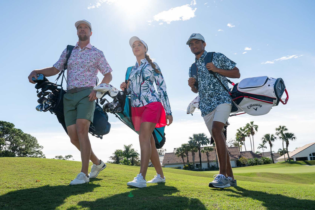 An image of golfers walking on the course. 