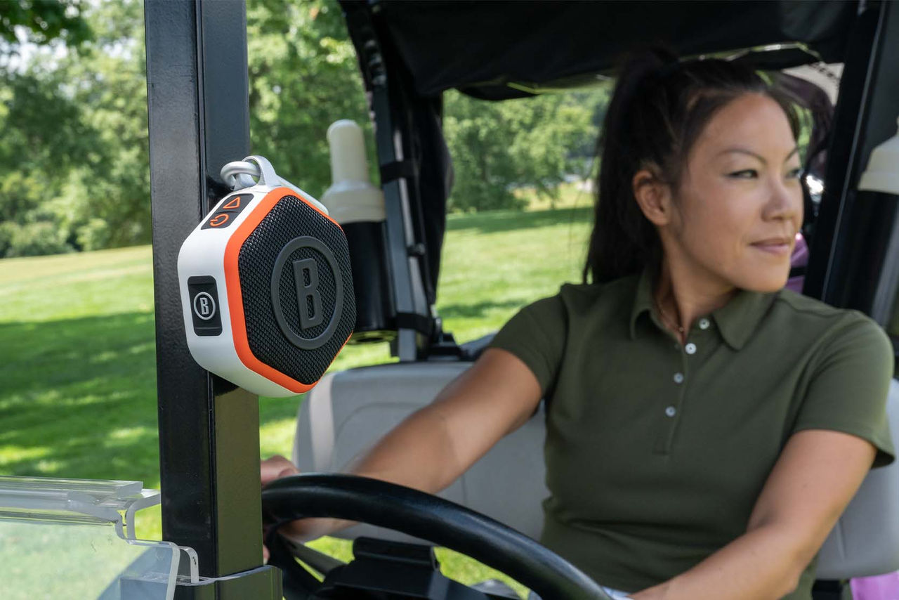 woman on golf cart with speaker