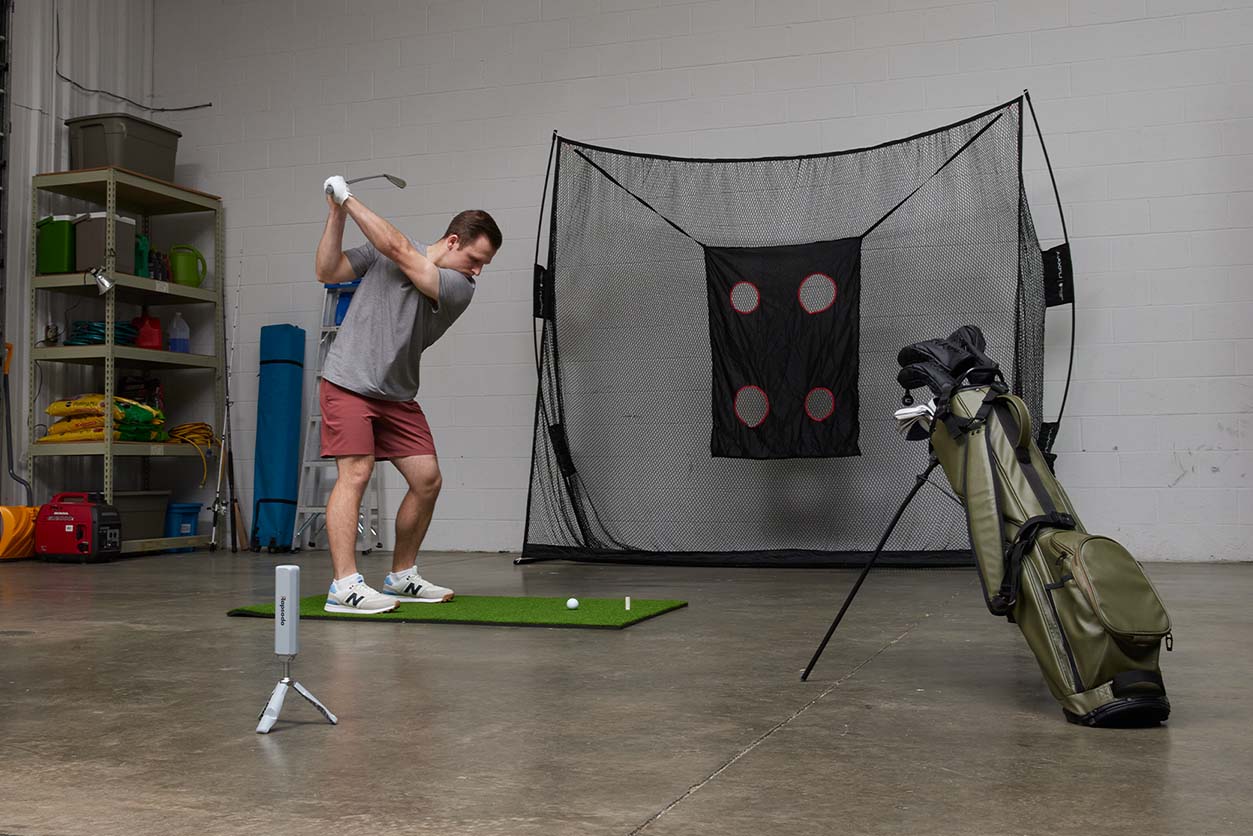 man practicing swinging into a net