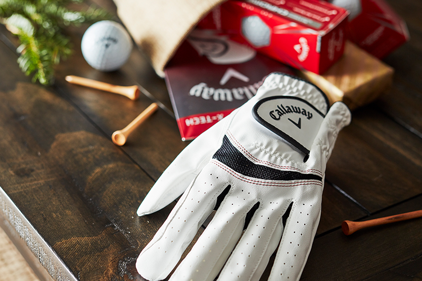 Golf glove on a table with golf tees