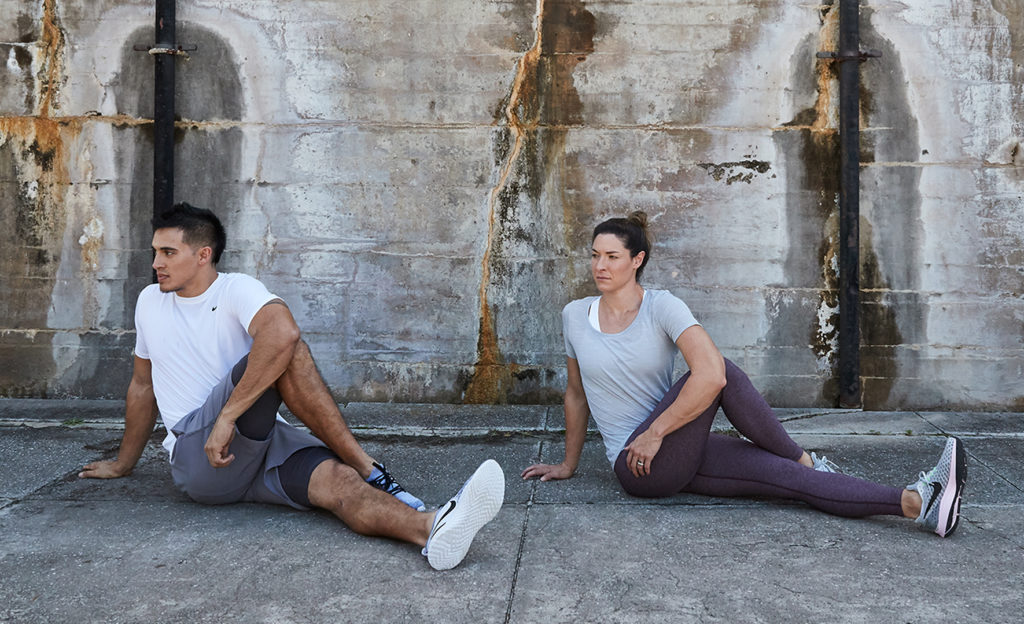 Man and Women doing a twisted glute stretch