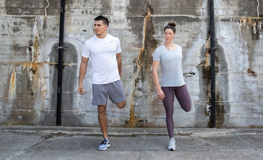 Man and Women doing a quad stretch