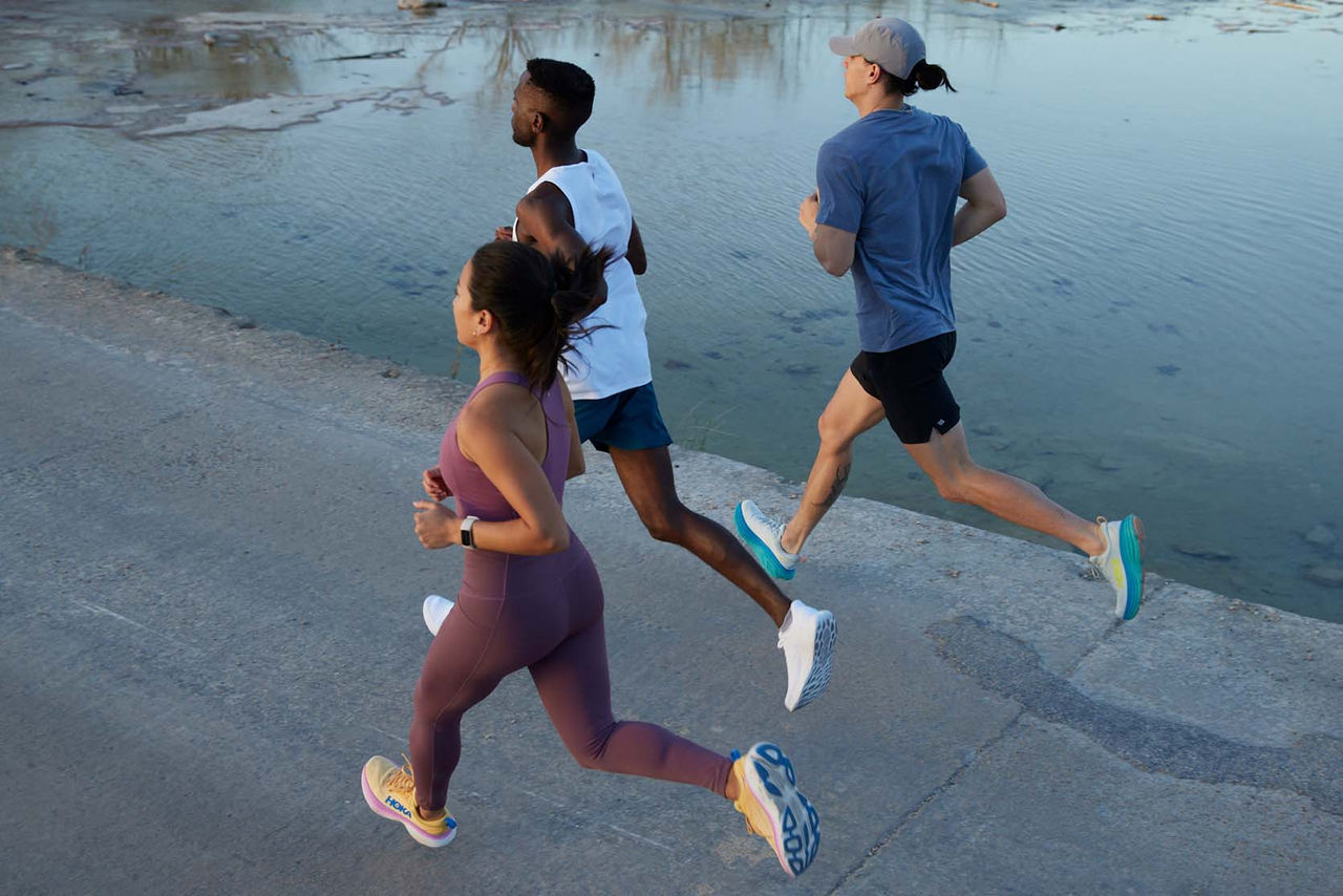 Woman running across bridge in blue tank top