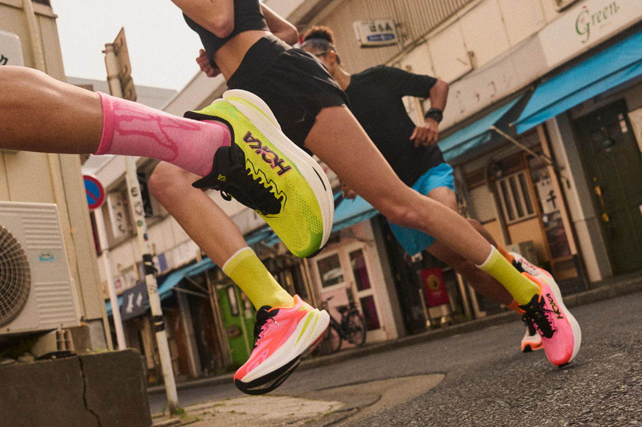 People running down an alley in Japan.
