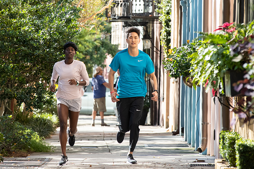 Picture of two runners running on the sidewalk.