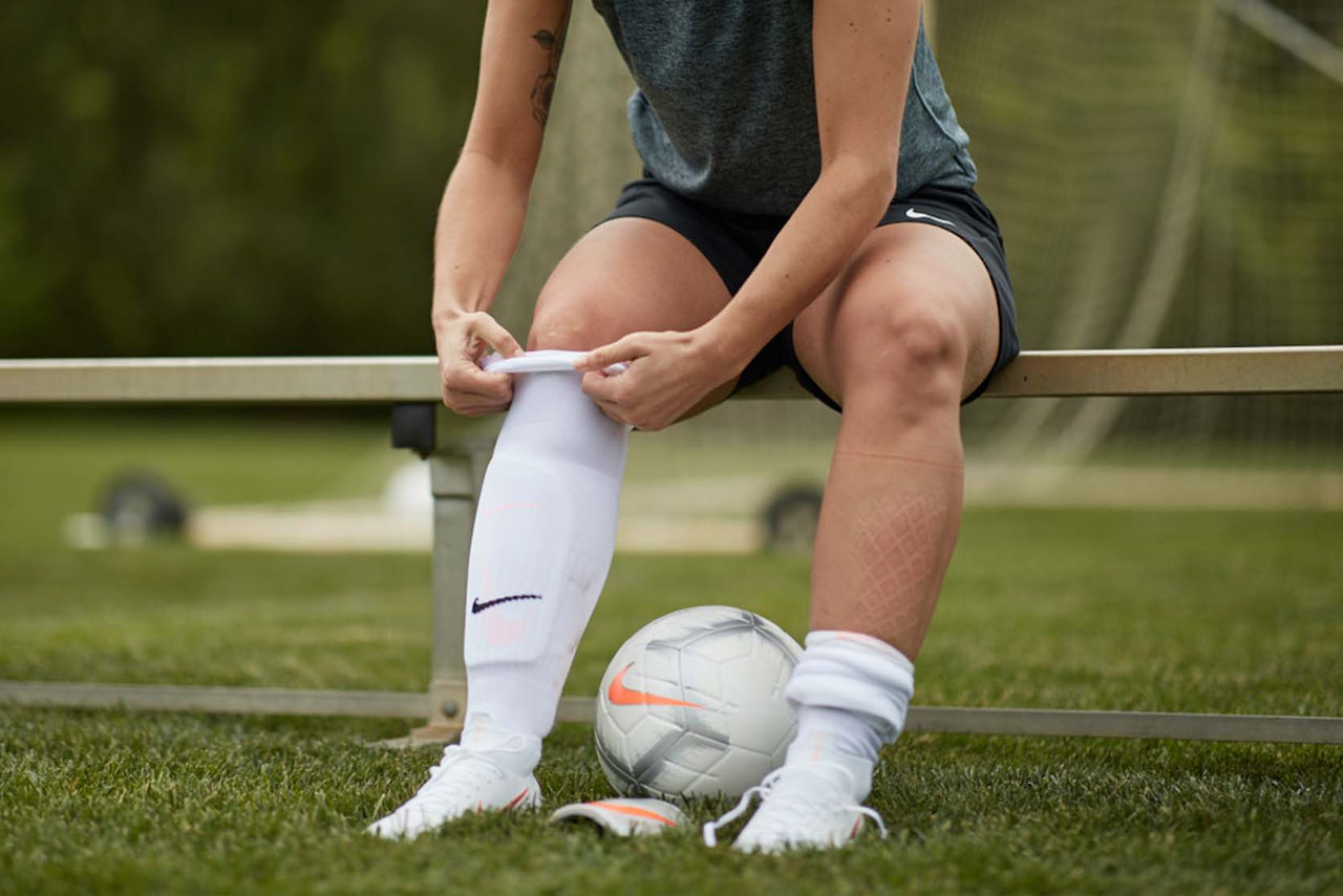 person pulling up Nike soccer socks