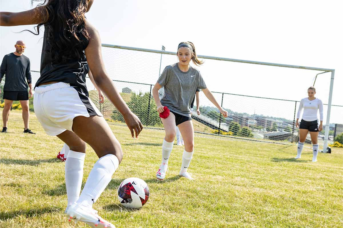Two teams playing soccer on a field
