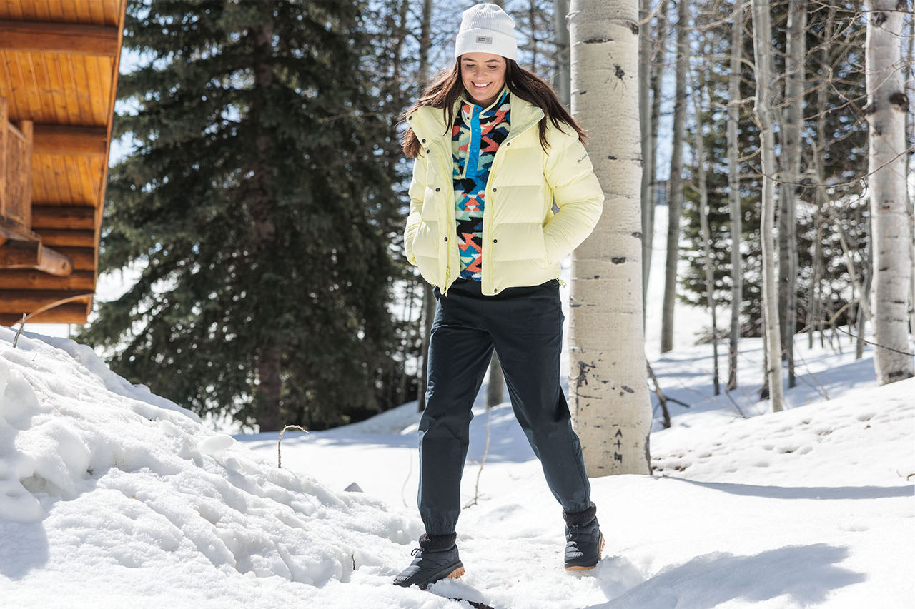 person in snow surrounded by trees