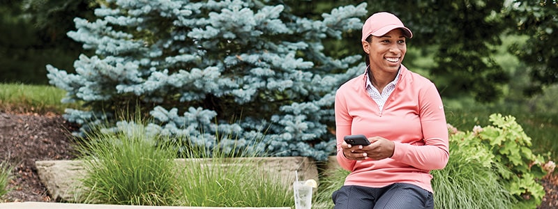 Woman with phone in a park.