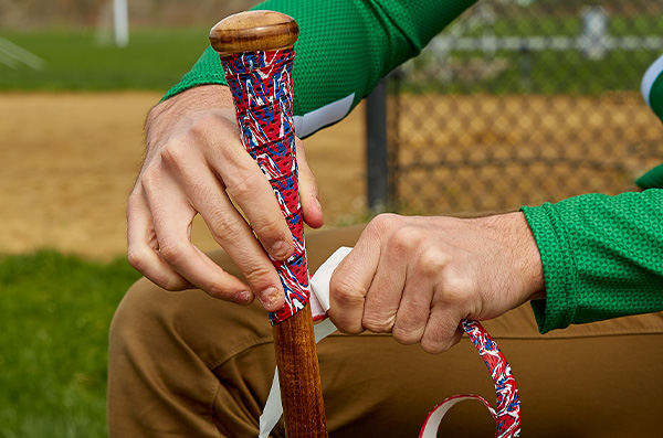 Man regripping a bat.
